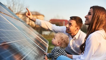Familie informiert sich gemeinsam über Photovoltaikmodule für ein energieeffizientes Zuhause